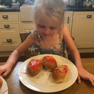 child looking at cakes she has made