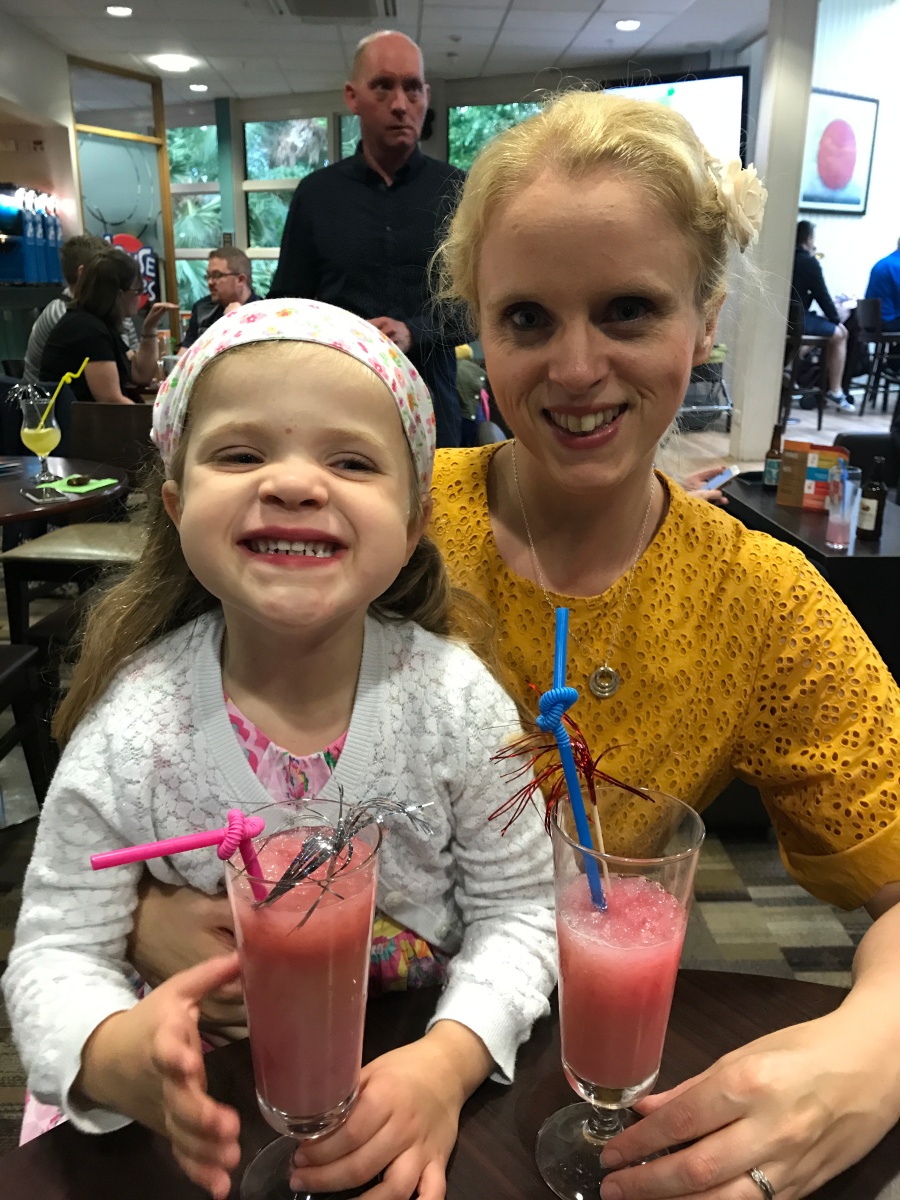 mom and daughter sharing fruit cocktails