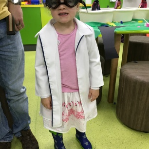 child dressed as mini scientist in lab coat and goggles